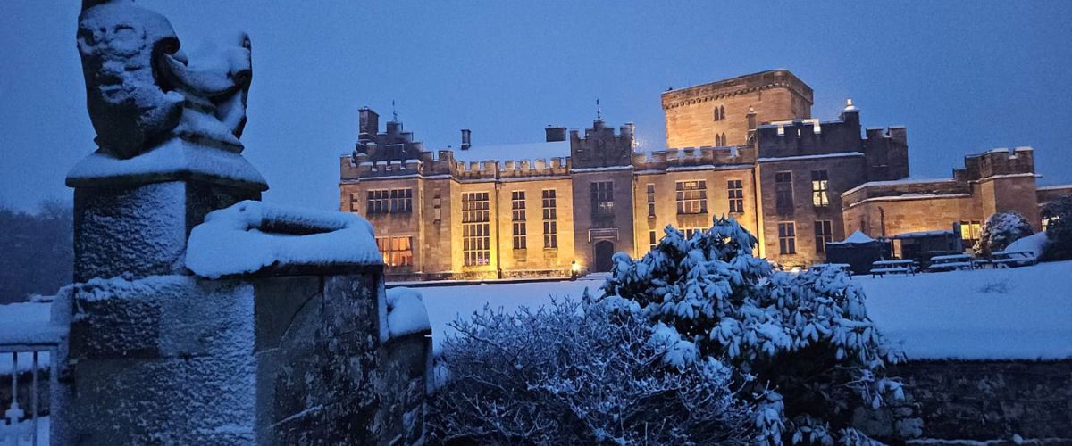 Exterior of Greystoke Castle in wintertime at dusk